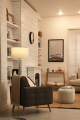 Stylish living room interior with comfortable armchair and decorative fireplace