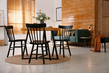 Stylish apartment interior with dining table and other furniture