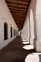 historic white building with rustic roof.