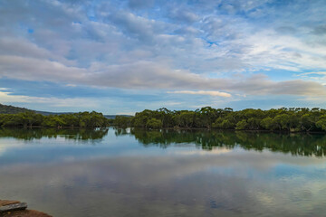 Clouds and reflections early morning waterscape