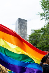 Large gay rainbow flag waving at an LGBT gay pride march in Mexico City