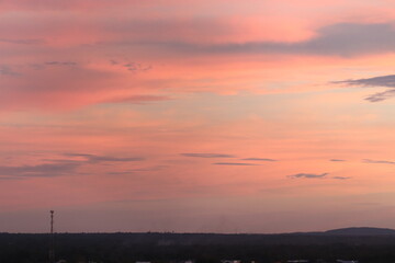 Beautiful late afternoon with sunset in colorful sky in shades of pink and orange taken in selective focus and macro photography.