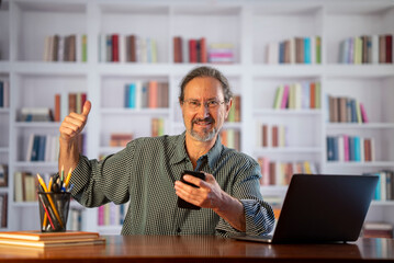 Portrait of successful man with phone very excited with success.