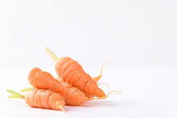 Organic carrots on white background, imperfectly shape