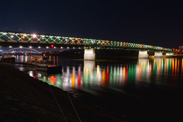 view of the Old city bridge in Bratislava at the night over the river with colorful  nightlights