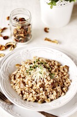 mushroom and barley risotto (Orzotto) - Italian home cooking. barley porridge with mushrooms.