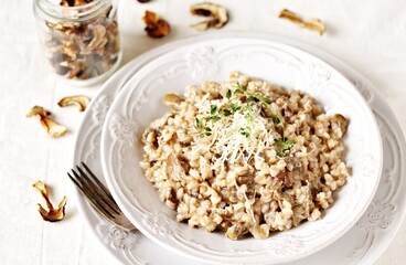 mushroom and barley risotto (Orzotto) - Italian home cooking. barley porridge with mushrooms.