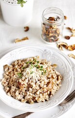 mushroom and barley risotto (Orzotto) - Italian home cooking. barley porridge with mushrooms.