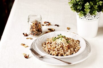 mushroom and barley risotto (Orzotto) - Italian home cooking. barley porridge with mushrooms.