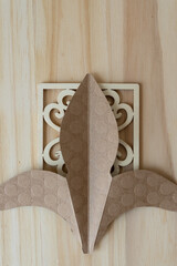 decorative paper shape on a fancy wooden square and wood background