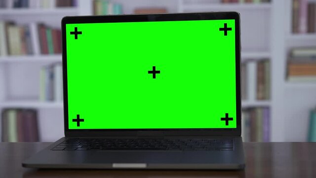 Copy space template turning close up shot of modern laptop with chroma key green screen set up for work in home or office concept.