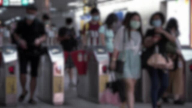 Defocused shot of Taiwaneses travellers wear mask at Metro Station to prevent infection coronavirus. The virus has caused emergency situation arround the world