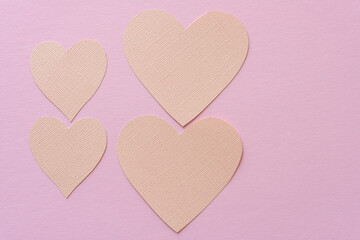 background design with paper hearts on pink