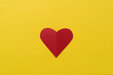 background design with red paper heart on yellow