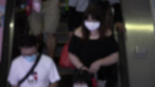 Blurred defocused taiwaneses travellers wear mask at Metro Station to prevent infection coronavirus. The virus has caused emergency situation arround the world