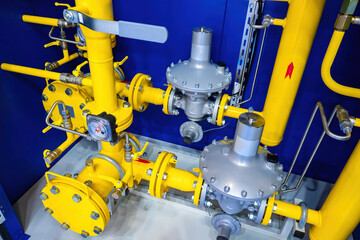 Gas distribution equipment. Pressure meter on the gas pipeline. Yellow pipes with plugs and valves....