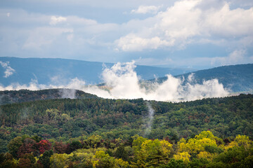 Morning fog clouds sky weather dramatic rising mist in early fall autumn foliage season on road to Dolly Sods, West Virginia mountains near Wardensville, WV