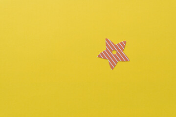 striped paper star on yellow