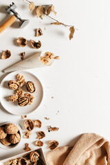 Cosy autumn aesthetic composition with dry  leaves, walnuts on white background. Flat lay, top view, copy space.