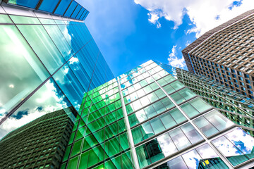 London, UK looking up on blue sky cityscape skyline exterior of office financial bank buildings in...