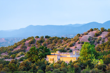 Naklejka premium High desert mountain house home during summer sunset and twilight blue hour in Santa Fe, New Mexico