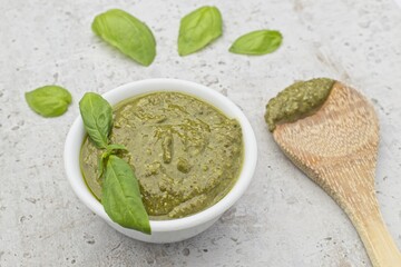 Close up of pesto and a wooden spoon.
