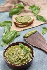 Bowl of pesto with basil and bread.