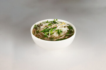 Vietnamese Pho Soup in a bowl on a plain white background