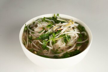 Vietnamese Pho Soup in a bowl on a plain white background