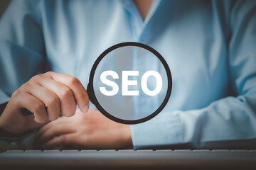 SEO Search Engine Optimization, Woman holding through magnifying glass with text SEO, concept for...