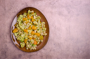 Fototapeta na wymiar Vegetables with beans and green sauce