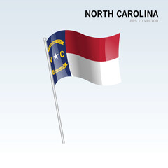Waving flag of North Carolina state of United States of America on gray background