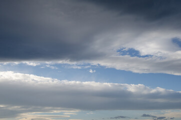 Obraz premium A light of blue sky through heavy clouds.