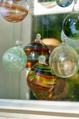 Multicolored glass balls in the window of a glass blowing workshop