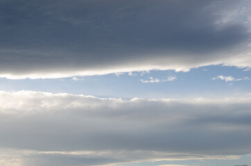 A light of blue sky through heavy clouds.