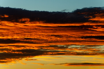 Fototapeta na wymiar Bright orange clouds at sunset, like lava.