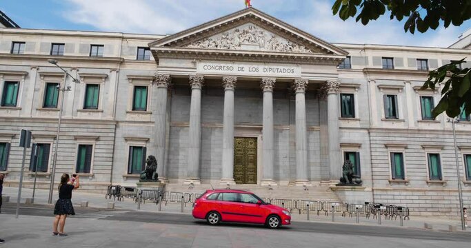 Woman Taking Photo Of The Main Facade Of Congreso de los Diputados In Madrid, Spain. wide