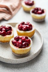 Mini cheesecake with cherry jam. One bite dessert. Tiny cheesecakes with berry. Valentine homemade present. Selective focus.