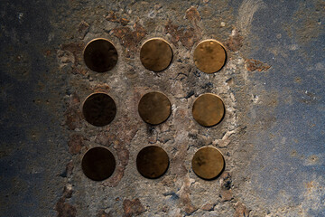 background of holes cut into a metal surface with traces of rust, detail for industry	