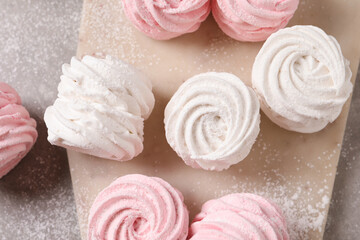 Delicious pink and white marshmallows on grey table, flat lay