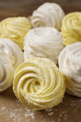 Delicious white and yellow marshmallows on parchment paper, closeup