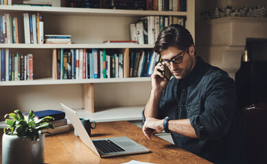 Time isn't on my side today. Shot of a handsome young businessman making a phone call while working in his office at home.