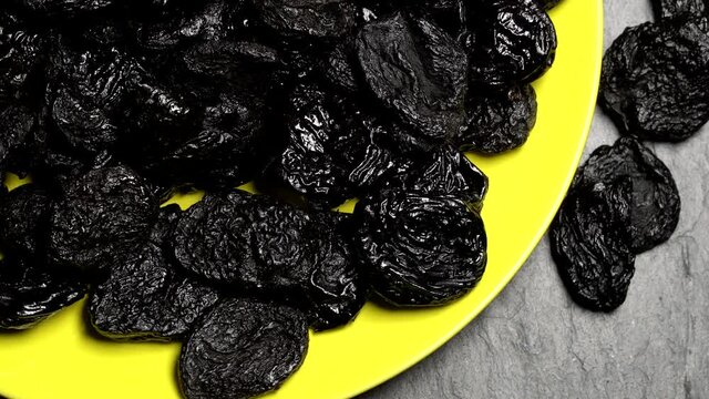 Dried plums (prunes) rotation background. Close up