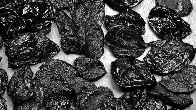 Dried plums (prunes) rotation background. Close up