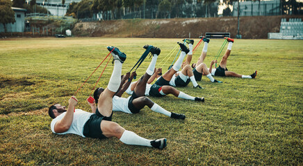 Rugby requires strong muscles. Full length shot of a group of young rugby players training with...