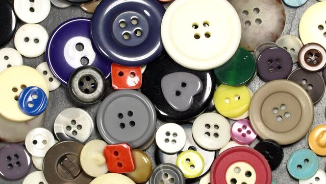 Various plastic sewing buttons rotation background. Close up. Loop motion