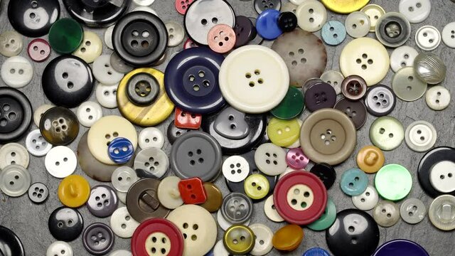 Various plastic sewing buttons rotation background. Close up. Loop motion