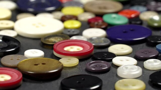 Various plastic sewing buttons rotation background. Close up. Loop motion