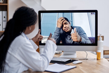 Thanks for your help, doc. Shot of a young man showing thumbs up during a video call with a doctor on a computer.