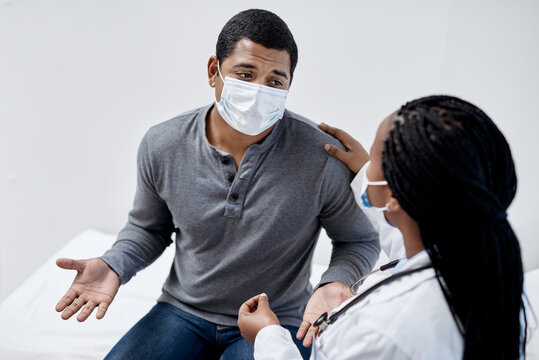 Give It To Me Straight, Doc. Shot Of A Young Man Having A Consultation With A Doctor.